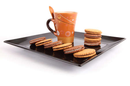 Cup of tea with biscuits on black Dish, breakfastの写真素材