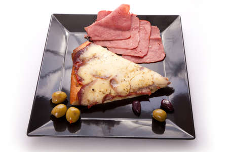 A Slice of supreme pizza being lifted up with olive の写真素材