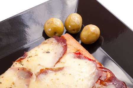 A Slice of supreme pizza being lifted up with olive の写真素材