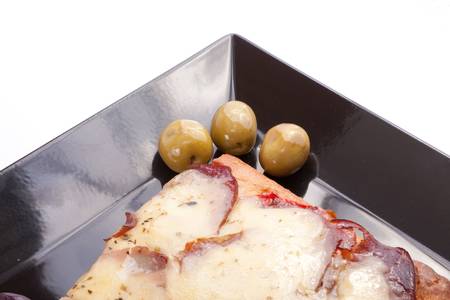 A Slice of supreme pizza being lifted up with olive の写真素材