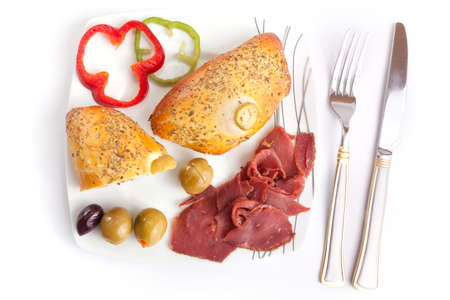 Bread stuffed Pastrami with olive on white dishの写真素材