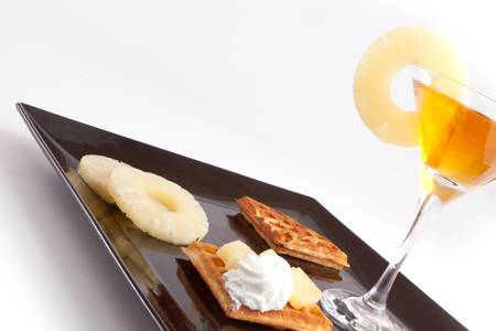 Pineapple Tart Slices with Fresh Juice In Cocktail Cup on Dishの写真素材