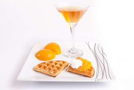 Peach Tart Slices with Fresh Juice In Cocktail Cup on Dishの写真素材
