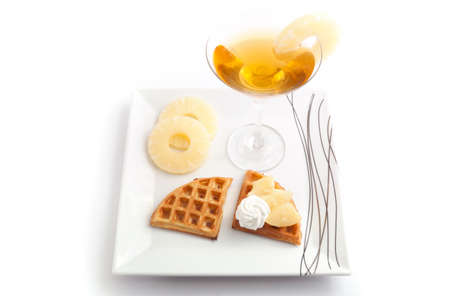 Pineapple Tart Slices with Fresh Juice In Cocktail Cup on Dishの写真素材