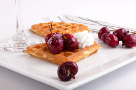 Cherries Tart Slices with fresh vanilla cream on white dishの写真素材