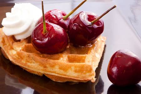 Cherries Tart Slices with fresh vanilla cream on dishの写真素材