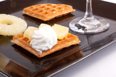 Pineapple Tart Slices with fresh vanilla cream on white dishの写真素材