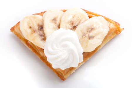 Banana Tart Slices with fresh vanilla cream on white dishの写真素材