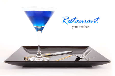 Restaurant Design Blue drink in a cocktail glass in black dish with fork and knife の写真素材