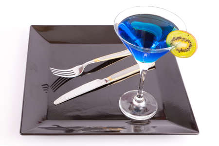 Restaurant Design Blue drink in a cocktail glass in black dish with fork and knife の写真素材