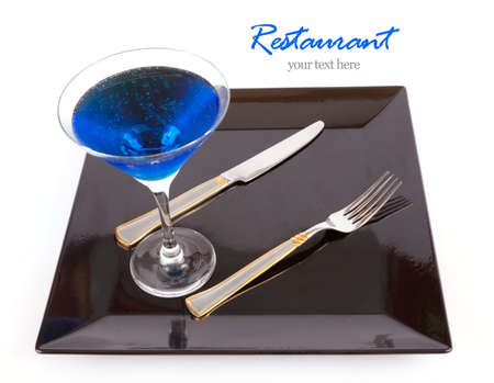 Restaurant Design Blue drink in a cocktail glass in black dish with fork and knife の写真素材