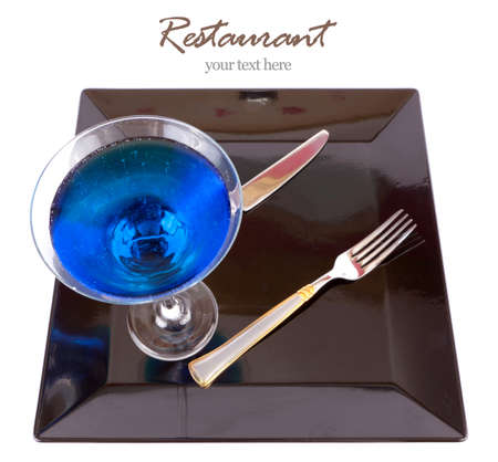 Restaurant Design Blue drink in a cocktail glass in black dish with fork and knife の写真素材