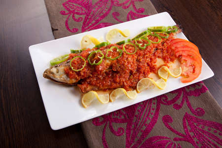 Fish with hot Sauce , lemon and pepper with riseの写真素材