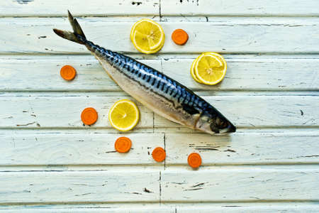 mackerel fish on white plate with lemonの写真素材