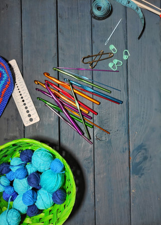everything for needlework hooks, threads, ruler, needle, measuring tape, top view on a wooden backgroundの写真素材