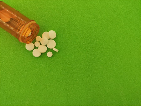 special purpose drugs for serious illnesses, pills on a green background with a brown bottleの写真素材