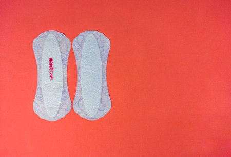 two pads on an orange background, menstruation cycleの写真素材