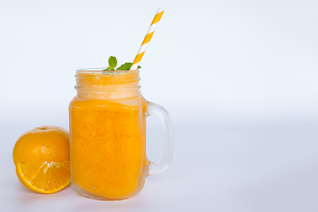 Orange  smoothies, fruit juices and fruit orange on a white wood background. Drink in the morning for good health.の写真素材