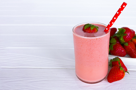 Strawberry yogurt smoothies and strawberry fruit on white woodの写真素材