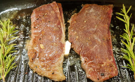 two pieces of beef steak with rosemaryの写真素材