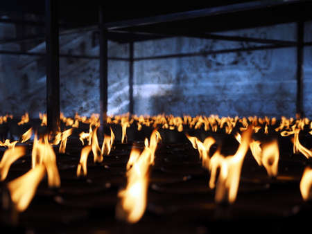 Burning lit candles at Chinese temple in Sichuan Province Chinaの写真素材