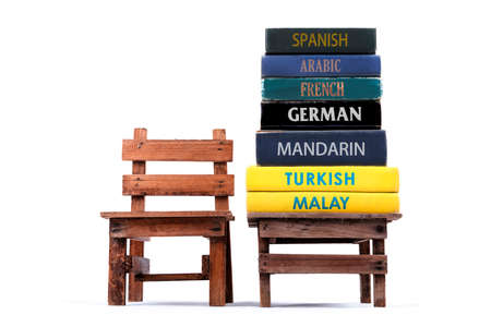 Dictionary books stacking on a table. White background.の写真素材