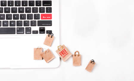 Online shopping concept. Online shopping keyboard with miniature of reusable grocery bags written FREE SHIPPING.の写真素材