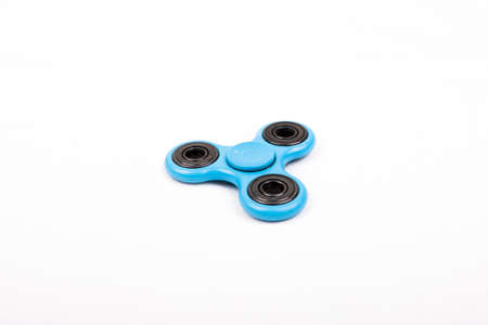 Blue fidget spinner stress relieving toy on a white backgroundの写真素材