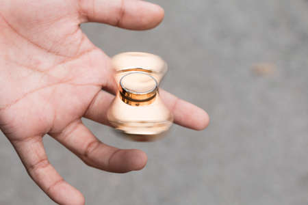 Kid plays with fidget spinner stress relieving toyの写真素材