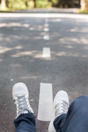Man sitting in the middle of the roadのeditorial素材