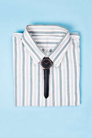 Wrist watch as a tie symbol on a formal shirt collar. Fashion concept.の写真素材