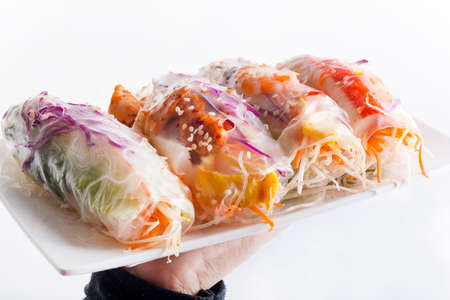 Vietnamese spring-roll on a white plate on a white background