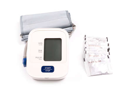 White sugar and blood pressure monitor isolated on a white background
