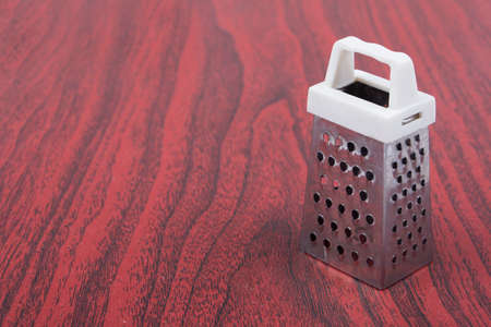 Kitchen tool grater on a wooden tableの写真素材