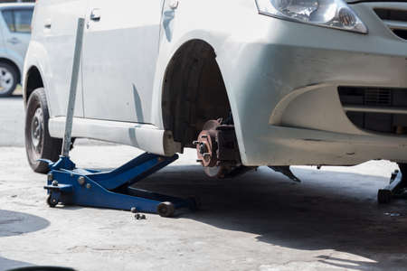 The car is being jacked for the tyre replacement.のeditorial素材