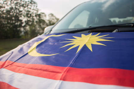 Independence Day concept - Malaysian flag on a Malaysian car.の写真素材
