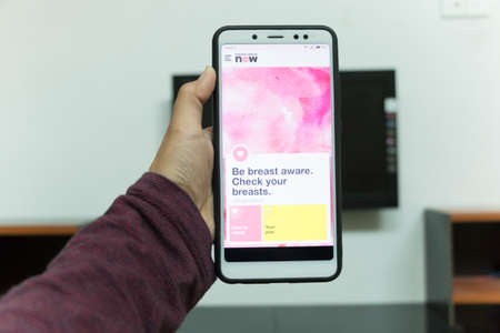 Negeri Sembilan, Malaysia - August 30, 2018: Breast Cancer Now application on smartphone. It is a breast health application dedicated for every woman's phone.のeditorial素材