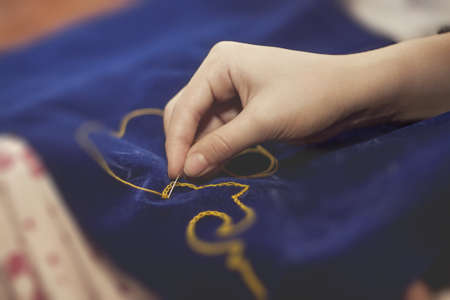 embroidery ornament on blue materialの写真素材