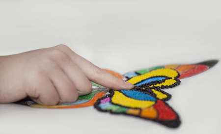 hand makes beaded butterfly on white paperの写真素材
