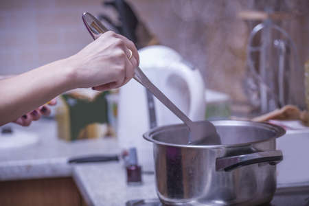 cooking pots and stirring the mixtureの写真素材