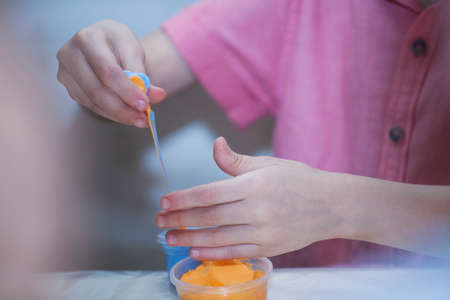 hands pulling plasticine for modelingの写真素材