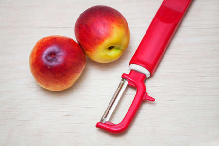 two peach and cleaning the knife on the Boardの写真素材