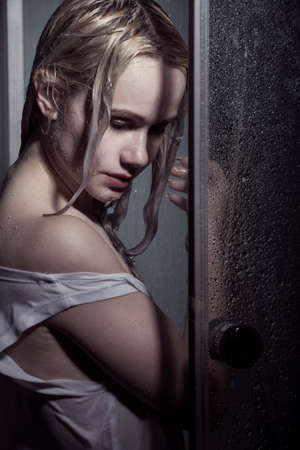 Portrait of beautiful woman bathing in darknessの写真素材