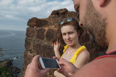 Man and woman with mobile phones, enjoying the view from the Fortの写真素材