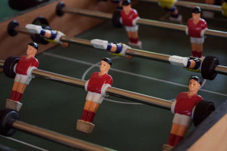 Tabletop foosball game with red and yellow figures