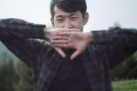 Young asian man yawningの写真素材