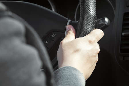 The driver's hand on the steering wheel