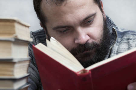 A bearded man with a red book, readsの写真素材