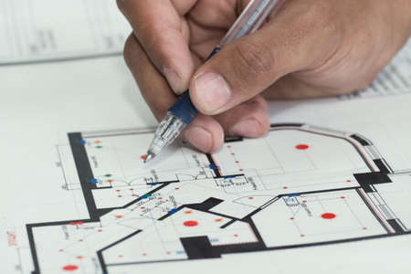 Real estate agent showing house plans to a businesssman