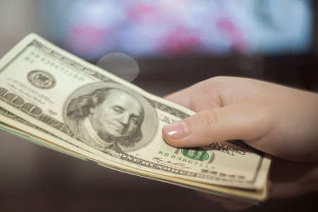 Female hand holding dollarsの写真素材